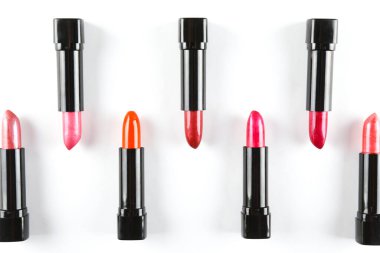 Beyaz arkaplanda izole edilmiş farklı parlak rujların yakın çekim görüntüsü ve metin için bir sürü kopya alanı.