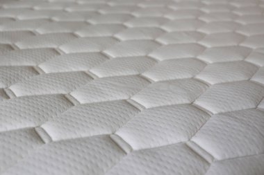 White orthopedic mattress with cell shaped patterns. Hypoallergenic foam matress for proper spinal alignment and pressure point relief. Close up, copy space for text, background. clipart