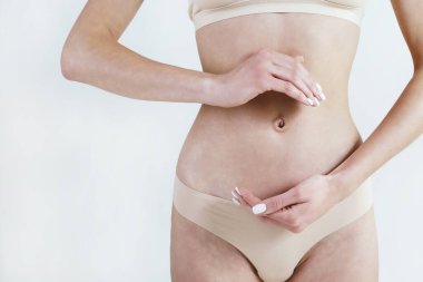 Kadının karnının üzerinde daire şeklinde bir şekil çizerken çekilmiş görüntüsü. Gut sağlık konsepti. Kapat, kopyala boşluk, arkaplan.