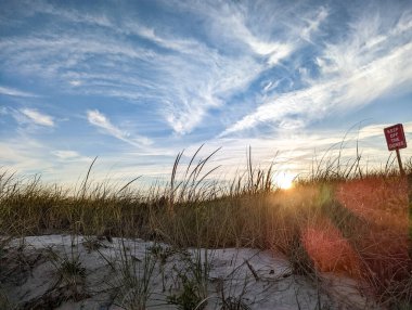 Sunsets behind the sand dunes on Fire Island in New York