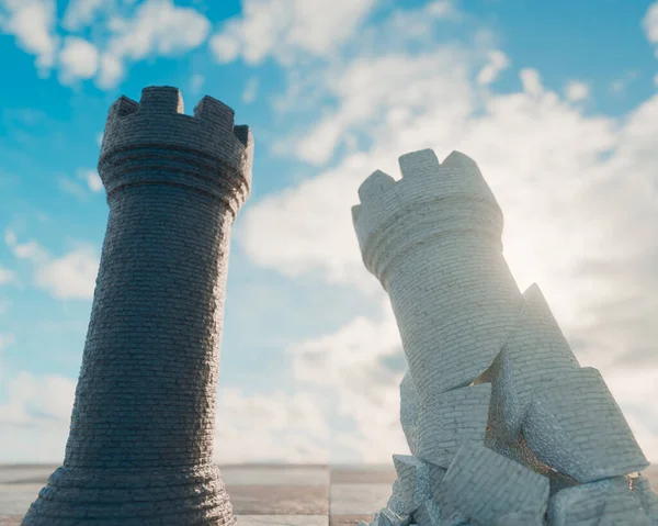 stock image A black chess castle opposing a crumbling white castle on a chess board surface and sky background  - 3D render