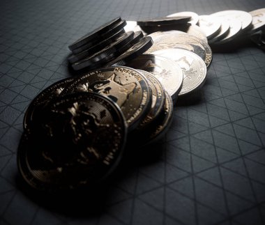 A fallen stack of gold physical dogecoin coins on line paper on a dark background - 3D render