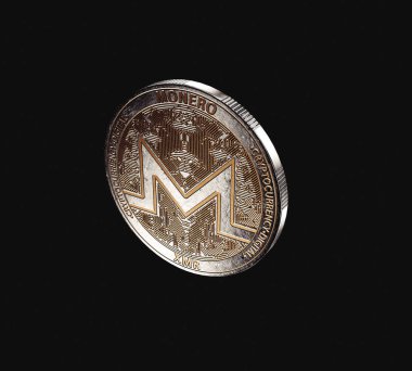 A dimly lit physical monero cryptocurrency in bronze and silver coin form on a dark studio background- 3D render
