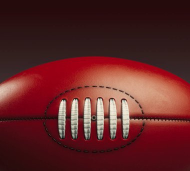 A generic unbranded aussie rules football ball on an isolated dark studio background - 3D render