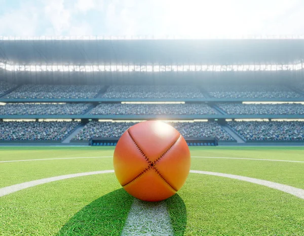 スタジアムの中央線にある赤いオージーのルールボールで 日中は緑色の芝生のピッチに投稿されます — ストック写真