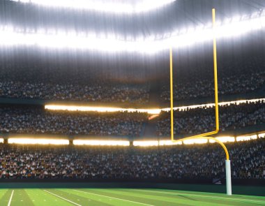 İşaretli yeşil çimenlik bir sahada geceleri ışıklandırılmış projektörlerin altında direkleri olan bir Amerikan futbol stadyumu.