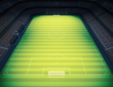 Gece vakti projektörlerin altında yeşil çimenlik alanda golleri olan bir futbol stadyumu.