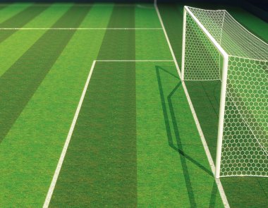 Gece vakti projektörlerin altında yeşil çimenlik alanda golleri olan bir futbol stadyumu.