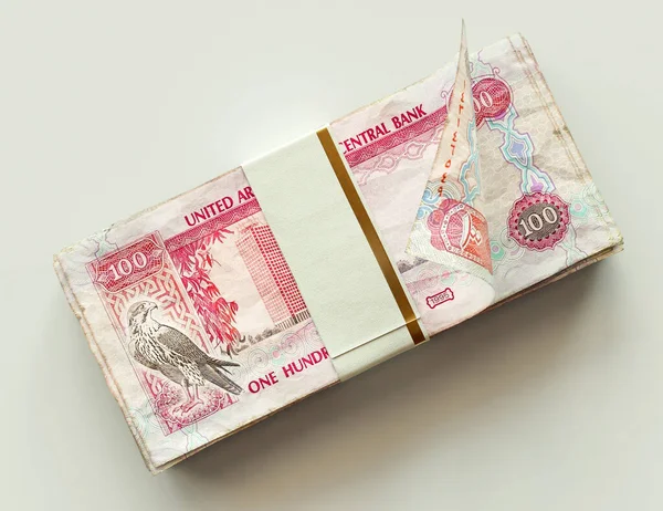 stock image A bundled wad of UAE Dirham banknotes on an isolated light background - 3D render