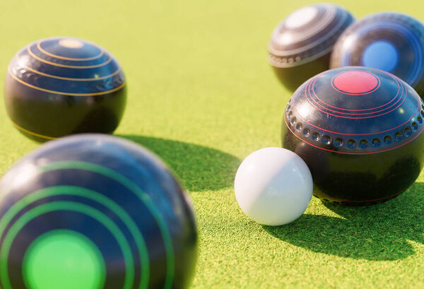 A set of old wooden lawn bowls next to a jack on a perfect flat green grass lawn outdoors - 3D render