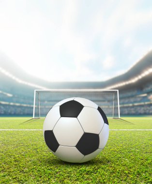 Gündüz vakti mavi bulutlu gökyüzünün altında top ve kale direkleri gösteren genel bir futbol stadyumu.