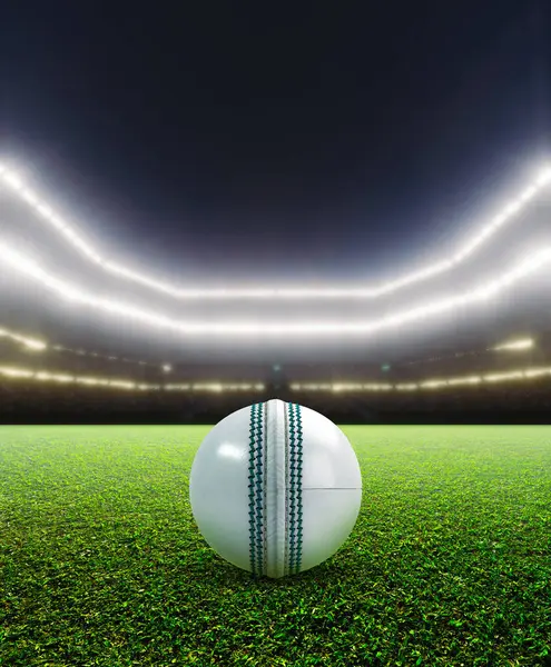 Parlak projektörlerin altında yeşil çimen yüzeyinde beyaz bir kriket topunu gösteren genel bir kriket stadyumu.