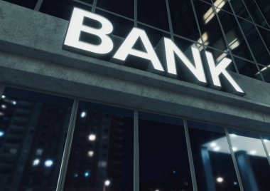 Gece vakti açıkta duran beton ve yansıtıcı camlardan yapılmış modern bir banka binasının girişinin üstündeki işaret.