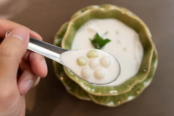 stock image Bua Loy is a traditional Thai dessert made of glutinous rice flour balls in coconut milk. The soft, chewy balls are usually colorful, and sometimes filled with sweet fillings. 