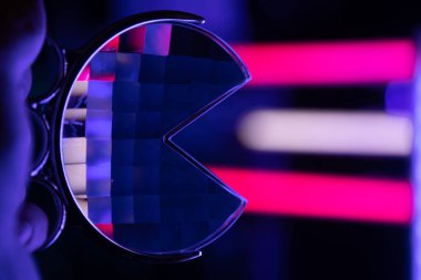 A beautiful glass fractal prism held in front of colorful LED lights. Glass reflections of light.