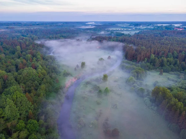 stock image Drone's Eye View: Serene Sunrise Over Misty River and Woodland Landscape in Northern Europe