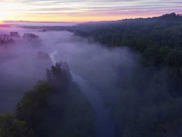 stock image Drone's Eye View: Serene Sunrise Over Misty River and Woodland Landscape in Northern Europe