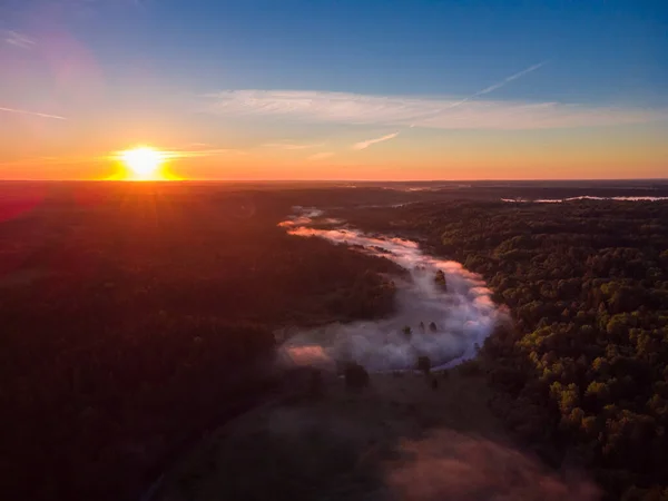 stock image Drone's Eye View: Serene Sunrise Over Misty River and Woodland Landscape in Northern Europe