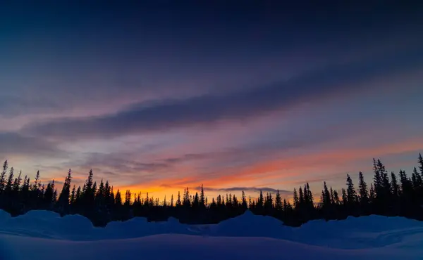 Arctic Splendor: Sunrise over Sweden\'s Snowy Wilderness with Colorful Skies in Northern Europe