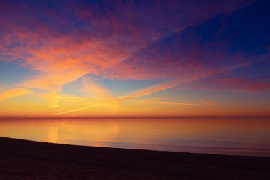 Baltık Denizi 'nde gün batımının güzel minimalist manzarası. Kuzey Avrupa 'nın renkli plaj manzarası.
