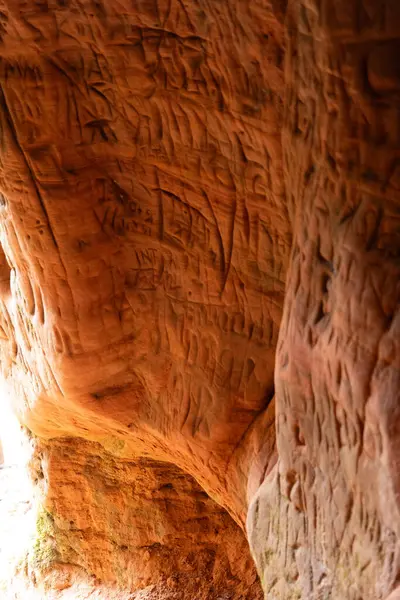 Stock image A beautiful sandstone cliff wall with engraved markings. Springtime scenery of Gauja National Park, Latvia.