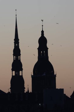 A beautiful Riga cityscape during colorful sunrise. Buildings against colorful sky. Norther Europe morning with warm sky.