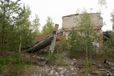 An old, collapsed building in soviet army base in Latvia, Europe. Abandoned white brick building.