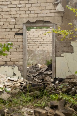 An old, collapsed building in soviet army base in Latvia, Europe. Abandoned white brick building.