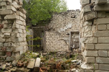 An old, collapsed building in soviet army base in Latvia, Europe. Abandoned white brick building.
