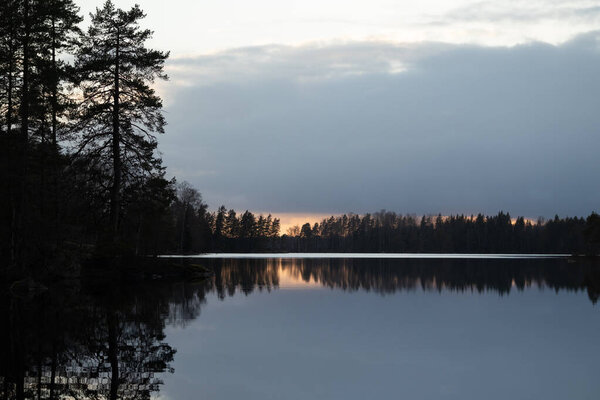 A beautiful evening scenery ot the forest lake in Sweden. Springtime landscape of Scandinavia.