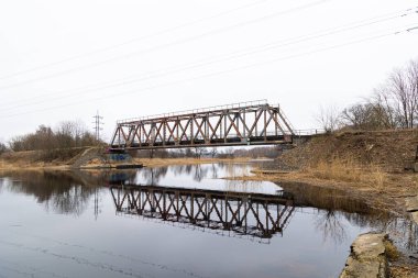 Nehrin üzerinde eski bir metal köprüsü olan güzel bir bahar manzarası. Riga, Latva 'da Doğal Bahar Manzarası.