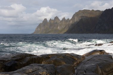 Okyanus dalgaları Norveç, Senja 'daki kayalık Tungeneset plajına çarpıyor. İskandinavya 'nın mevsimlik manzarası.