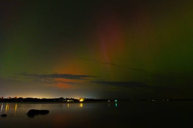 Letonya üzerinde sonbahar gökyüzünde güzel bir kuzey ışığı gösterisi. Aurora Borealis un Baltis Country gecesi. Kuzey Avrupa 'nın mevsimlik manzarası.