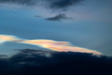 Norveç 'te kışın gökyüzünde nadir görülen bir kutup stratosferik bulut görüntüsü. Gökyüzünde güneş ışınları içinde renkli buz kristalleri. Kış mevsiminde İskandinavya 'da Kuzey Kutbu doğası.
