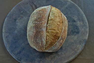 Artisan Sourdough Bread loaf on a pizza stone direct from the oven