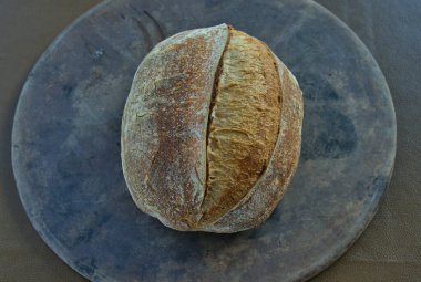 Artisan Sourdough Bread loaf on a pizza stone direct from the oven