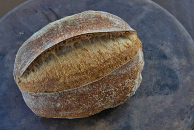 Artisan Sourdough Bread loaf on a pizza stone direct from the oven