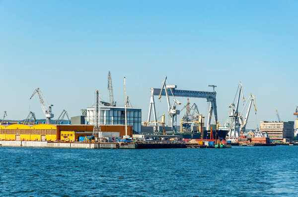 Harbour in Gdynia, Poland. General view with port cranes, buildings and docks 