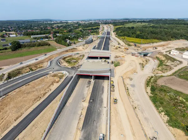 Stock image New Northern part of circular highway bypass around Krakow under construction. Fragment S52 joining A4 with S7 with Zielonki junction with tunnels and traffic circle. State in August 2024. Aerial view