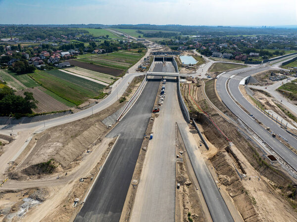 Tunnel and viaduct in Northern part of circular highway bypass around Krakow under construction near Zielonki Junction on S52 aiming to join A4 with S7. State in August 2024. Aerial view
