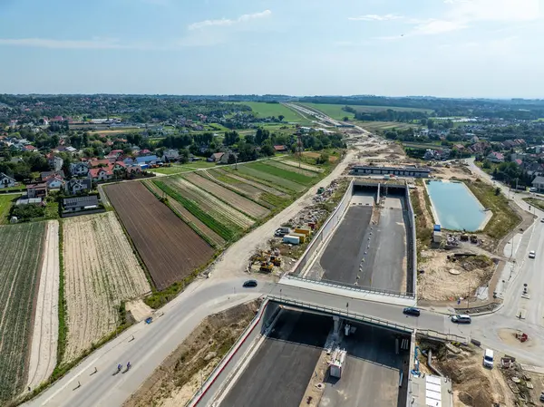 stock image Tunnel in Northern part of circular highway bypass around Krakow under construction near Zielonki Junction on S52 aiming to join A4 with S7. State in August 2024. Aerial view