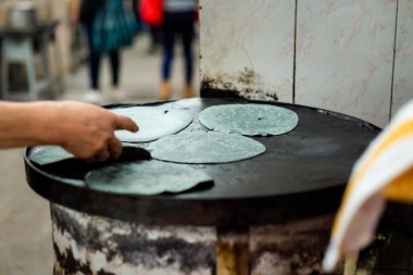 Preparing fresh blue corn tortillas on local market in Puebla. Traditional mexican cuisine made of fresh ingredients.