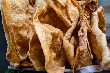 Fresh prepared pork belly skin chicarron served in local market in Puebla. Traditional mexican cuisine made of fresh ingredients.