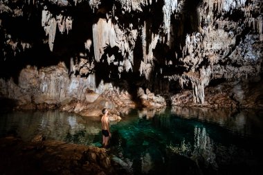 Young handsome man in Dzalbay, Sac Aua cenotes in Mexico, Valladolid area. Vivid landscape photo with lush green and crystal water