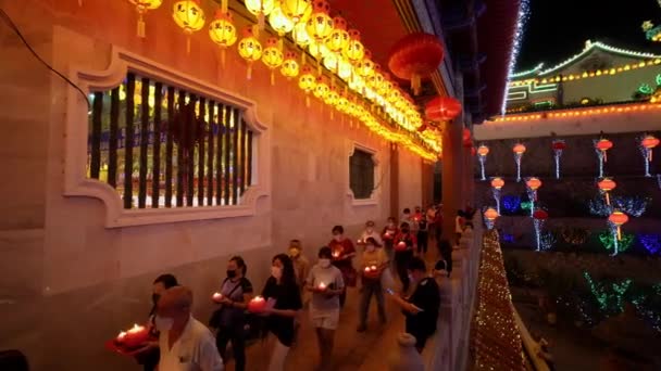 2022年2月27日 仏教の巡礼者が蓮のキャンドルランプを持って裸の足でKek洛シリコン寺院の周りを歩く — ストック動画