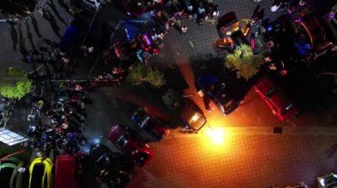 Juru, Penang, Malaysia - Oct 08 2022: Aerial rotate look down spit fire performance in night during auto city carnival. Gathering of car club
