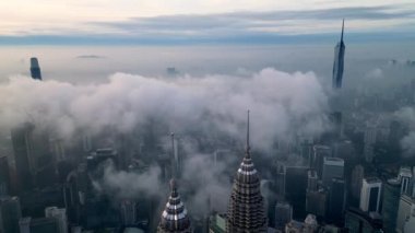 Bukit Bintang, Kuala Lumpur, Malaysia - Nov 13 2022: Aerial move toward KLCC twin tower with TRX 106 and PNB 118 skyscraper in low cloud