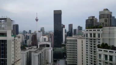 Bukit Bintang, Kuala Lumpur, Malaysia - Dec 26 2022: Aerial move toward Pavilion with background of KL tower