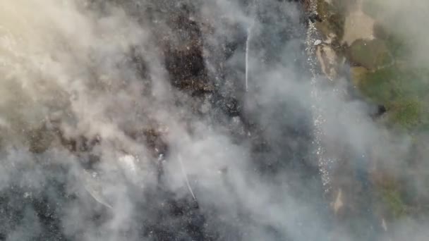 Aerial Top View Fire Hose Spray Burning Garbage Dump Site — Αρχείο Βίντεο