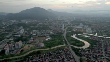 Aerial view winding river Sungai Juru with background of Bukit Mertajam hill